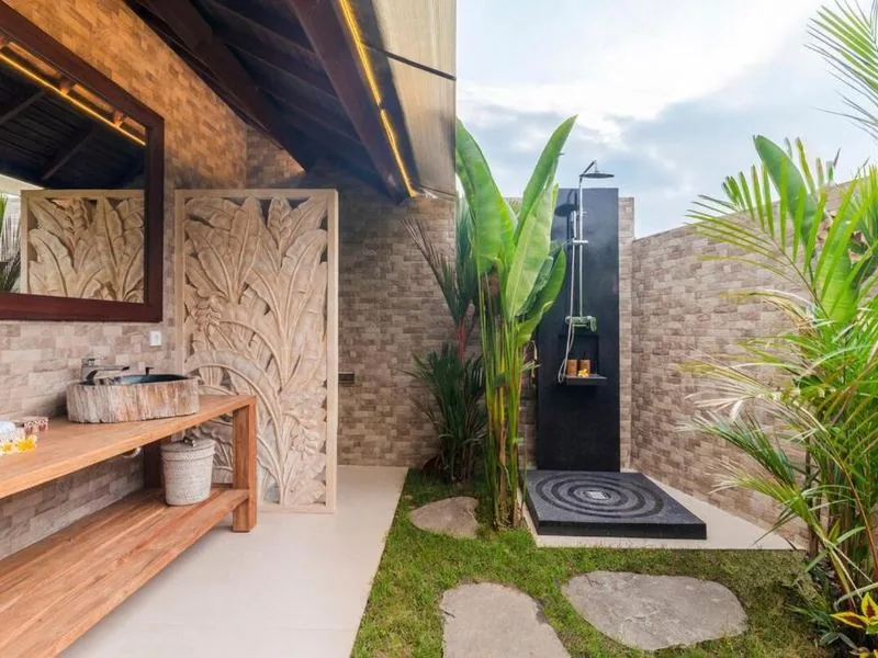 Outdoor rain shower with stone carvings