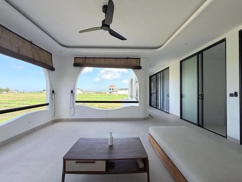 Open living area with rice field views — Villa Cemagi