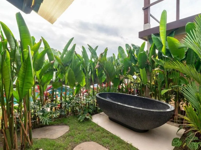 Outdoor stone bathtub in tropical garden