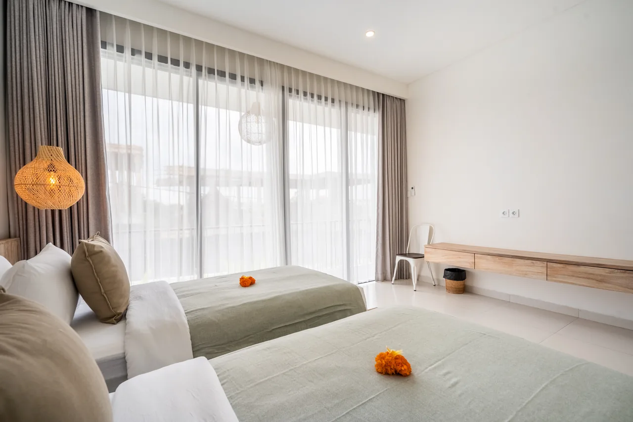 Villa Jucca second bedroom in sage tones