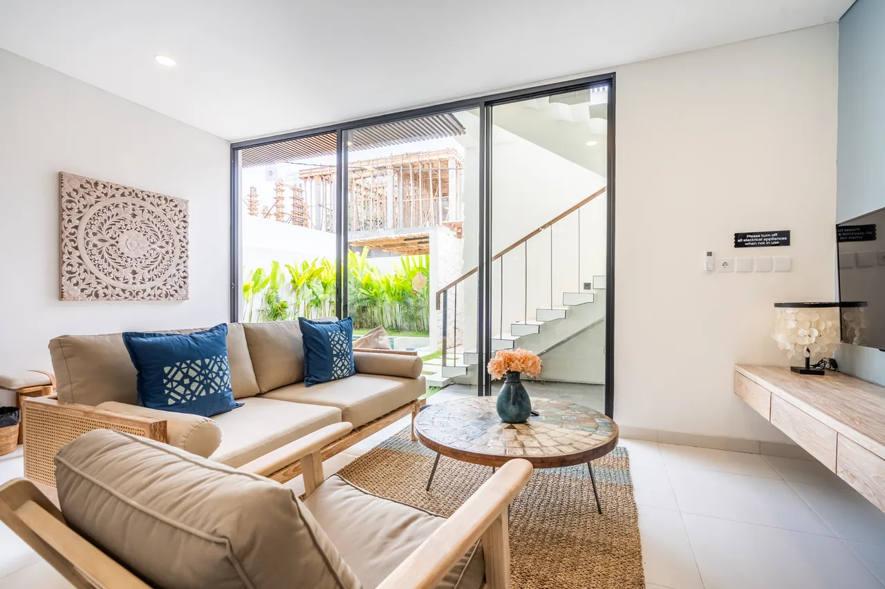 Villa Jucca open living room with staircase and garden view