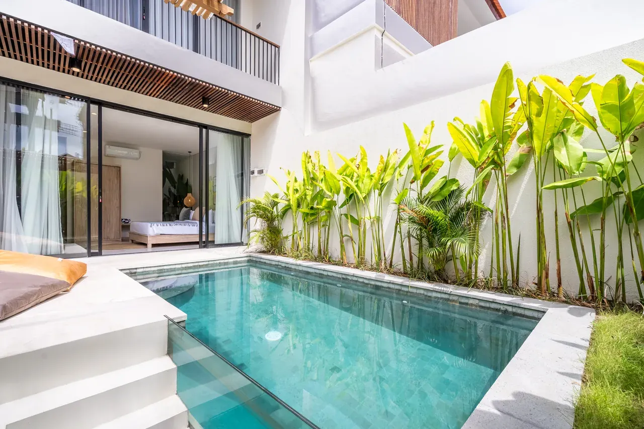 Villa Jucca green-tiled pool and arched teak door