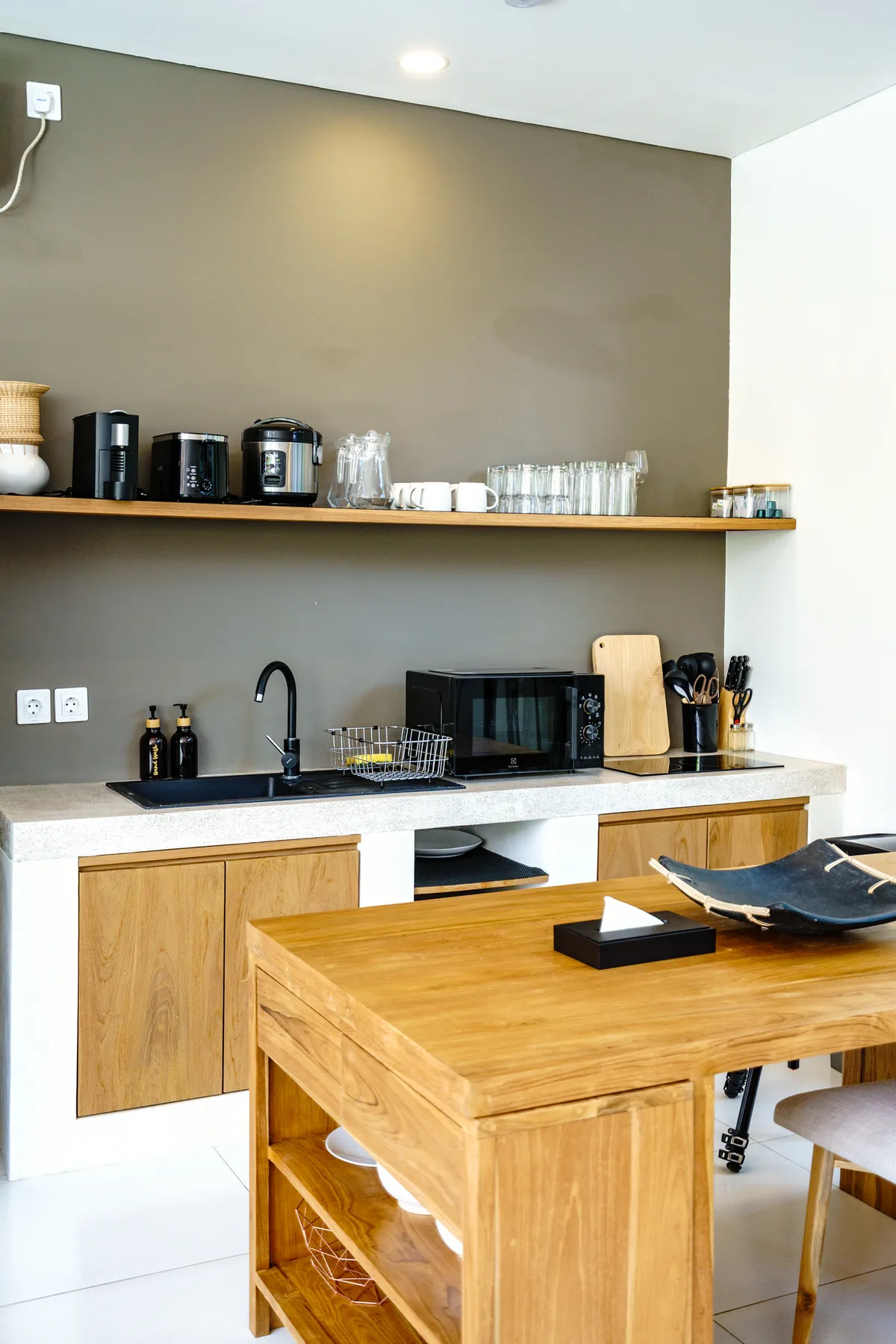 Villa Oasis open kitchen with terrazzo counters and teak joinery